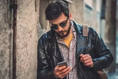 Man checking Coffee Meets Bagel app