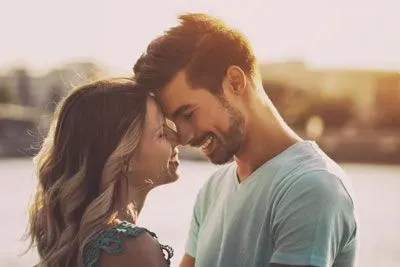 Ivy League couple hugging outside by a lake