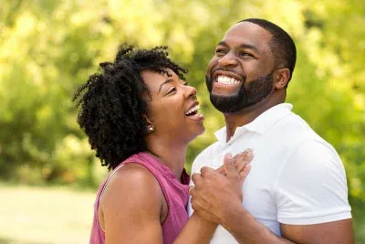 Couple who met through a matchmaker in New Orleans embracing in a park