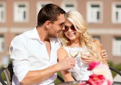 Couple toasting with white wine on a date