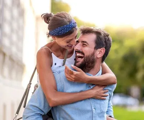 Happy couple hugging outside