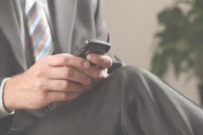 Man in suit texting