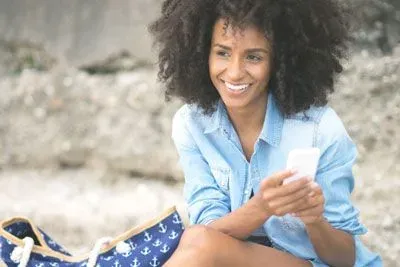 Woman sitting outside checking Tinder