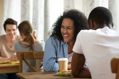 Woman laughing and having fun on a speed date