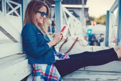 Woman watching a Tinder Loop at the beach