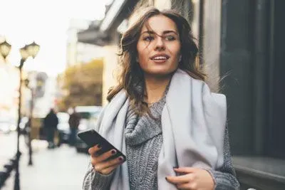 Woman checking Facebook on her mobile
