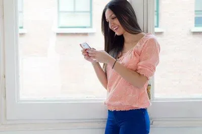 Woman in her apartment texting
