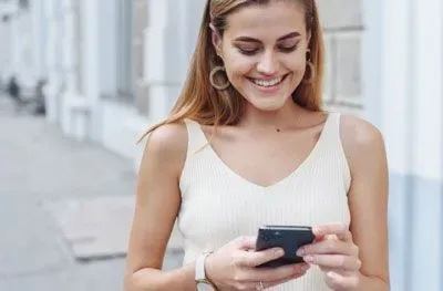Woman smiling as she's checking Tinder