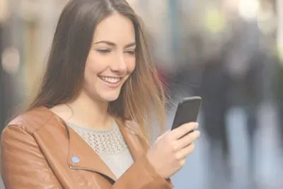 Woman smiling at a text she got on Tinder